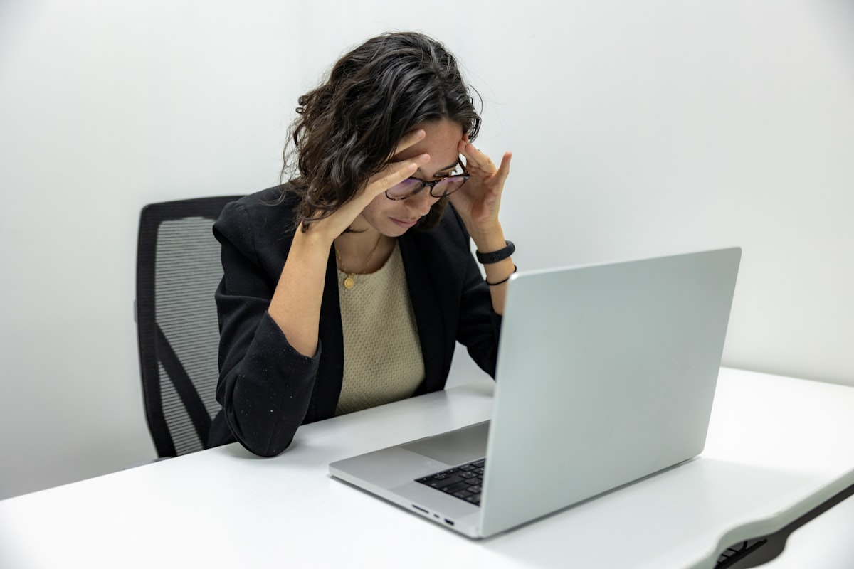 A person looking tired while working on a laptop