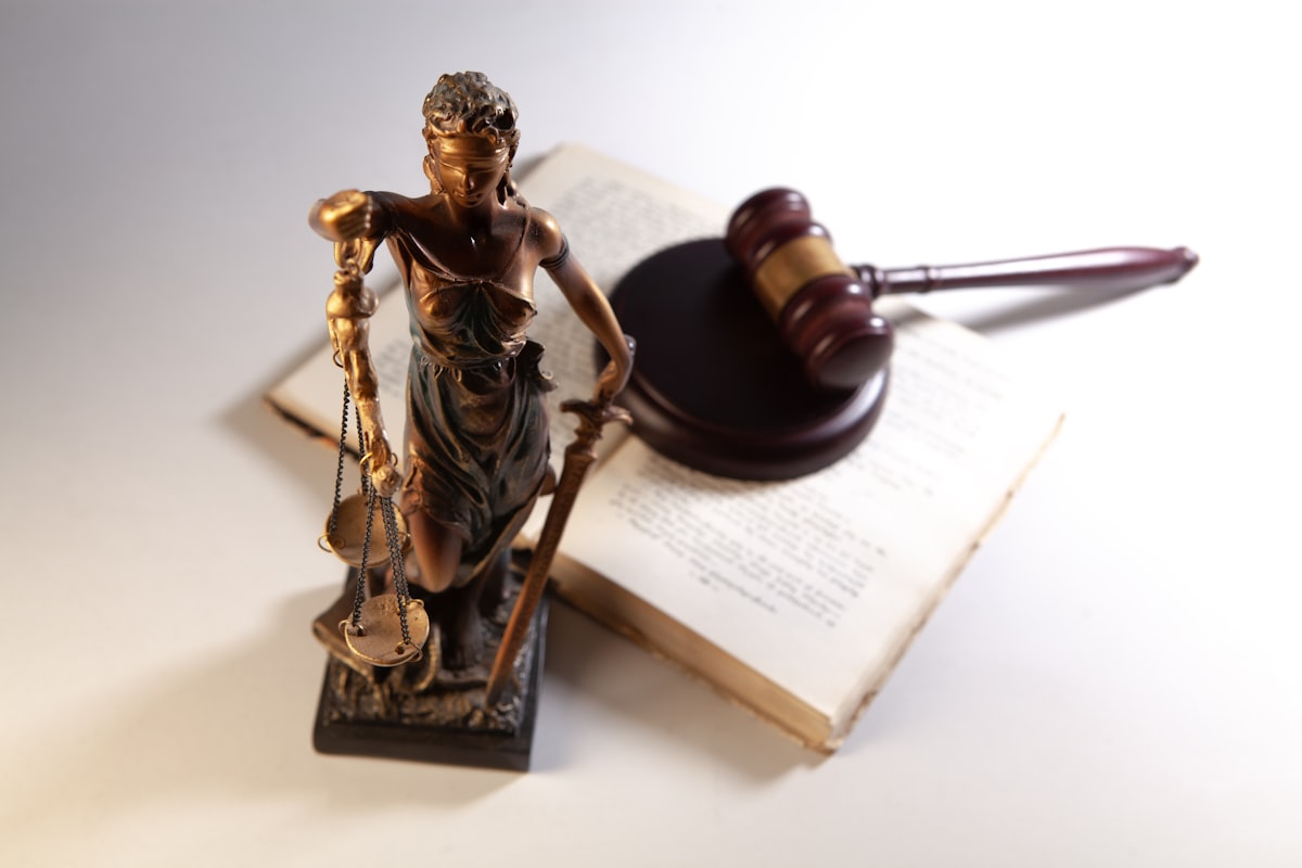A statue of justice with a gavel and an open book