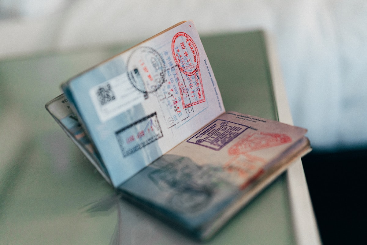 An open passport with multiple ink stamps on the pages