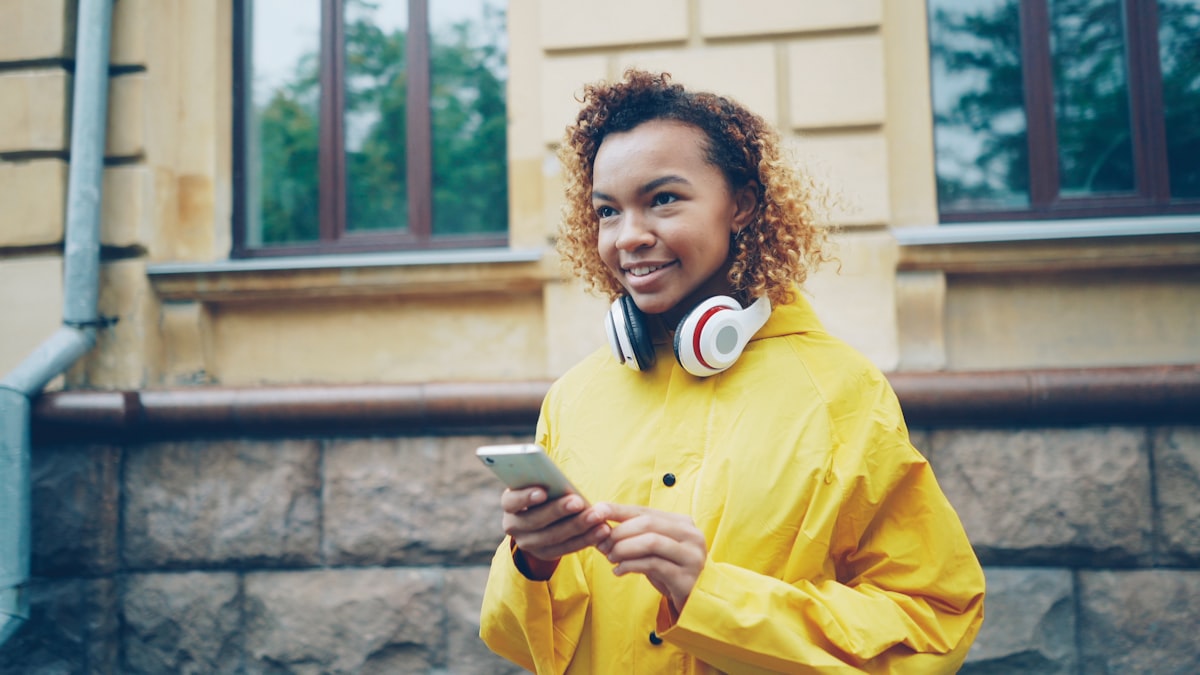 A young woman checking her phone outdoors